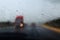 Drive car at heavy rain. Water drops at window