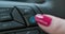 Driver activate autopilot mode. Female finger pressing autopilot button on modern electric car. Work radar traffic
