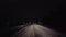 Driver Approaching Traffic Accident While Snowing on Rural Road at Night.  Driver Point of View POV Moving Toward Vehicle