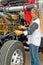 Driver checking oil and pre-trip inspection on a big truck.