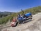 Driver on crawler tractor, climbs steeply up into the vineyards