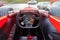 A driver driving a red Formula 1 sports car during a city race at high speed in traffic jams on the street. The spirit of