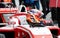 Driver helmet on racing single seater red car motorsport background