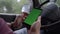 Driver holds modern phone with green screen with chromakey mockup