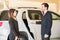 Driver opening door to businesswoman