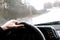 The driver rides behind the wheel of the car in rainy weather