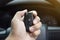 Driver`s hand holding the car keyless remote
