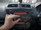 Driver& x27;s Hand Press Button on Car Radio