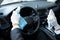 Driver Sanitizing Steering Wheel In Car