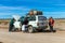 Driver and Tourists fix broken car during 4x4 Jeep Tour on Bolivian Altiplano, Bolivia