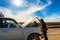 Driver and Tourists fix broken car during 4x4 Jeep Tour on Bolivian Altiplano, Bolivia