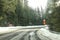 Driver view on sharp road curve, partially covered with snow in