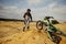 Driver walking to motorbike trapped in sand