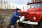 Driver of the water washes the old fire truck