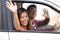 Drivers driving in car waving happy at camera