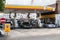 Drivers filling up with fuel at a British shell petrol station with cars on the forecourt