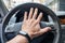 Drivers hand on a steering wheel of a car