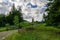 Driveway to the farm with welcome sign tree lined country road