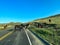 Driving through the badlands hills and mountains with Wild Horses standing in the road in Theodore Roosevelt National Park in