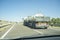 Driving behind B-double trailer loading tanks on divided highway road