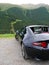 Driving a black cabriolet car in austrian Alps