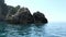 Driving with a boat long the paradise beach of liapades at Corfu Island Greece. Sedimentary rock cliff of chalk rocks