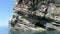 Driving with a boat long the paradise beach of liapades at Corfu Island Greece. Sedimentary rock cliff of chalk rocks