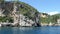 Driving with a boat from Paleokastritsa to Liapades beach at Corfu Island Greece. passing by sediment chalk rocks in the water.