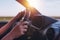 Driving car through countryside, female hands on steering wheel