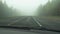 Driving car in dense fog. bad weather condition with zero visibility. Perspective view from cabin