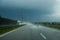 Driving the car on the highway during heavy rain.