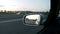 Driving car on the motorway in the morning - back mirror