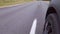 Driving a car on a motorway, moving wheels and roads. Low angle view