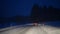 Driving car at night road in winter, snow, slippery blizzard weather mountains forest