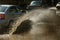 Driving cars on a flooded road during floods caused by rain storms. Cars float on water, flooding streets. Splash on the machine.