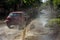 Driving cars on a flooded road during floods caused by rain storms. Cars float on water, flooding streets. Splash on the machine.