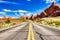 Driving through the-Desert with Monument Rock along the Road During Sunny Day, Arches NP