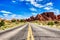 Driving through the-Desert with Monument Rock along the Road During Sunny Day, Arches NP