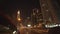 Driving on Dubai city streets at night. Car driving on multi lane highway surrounded by tall skyscrapers