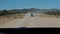 Driving on a dusty road between Opuwo and Sesfontein, Namibia