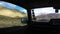 Driving on Dusty Trails with a Car Window View of Mountains and Clouds