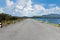 Driving on an empty road. Empty asphalt road through the green field and clouds on blue sky in summer day. Open road ahead, endles