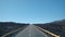 Driving on an empty road through a volcanic landscape from the black lava-covered volcano Teide Tenerife Canary Islands