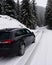 Driving a family car in winnter time on snowy road in italian mountains