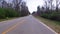 Driving first person view country road waste and trash on the side of the road building up