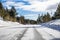 Driving on an ice and snow covered road through the Sierra mountains on a sunny day, Nevada