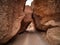 Driving through large stones at the bottom of the Valley of Castles. Charyn Canyon National Park