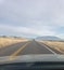 Driving looking through windshield at truck in front