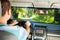 Driving man inside car with beautiful forest view