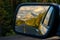 Driving through a mountain road and watching the beautiful scenery in the rearview mirror in the icefields parkway near Jasper